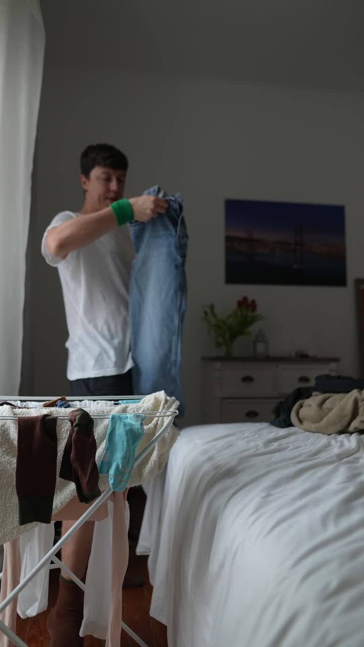 Person Drying Laundry in Bedroom
