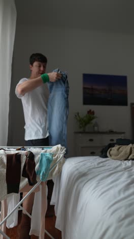 person drying laundry in bedroom