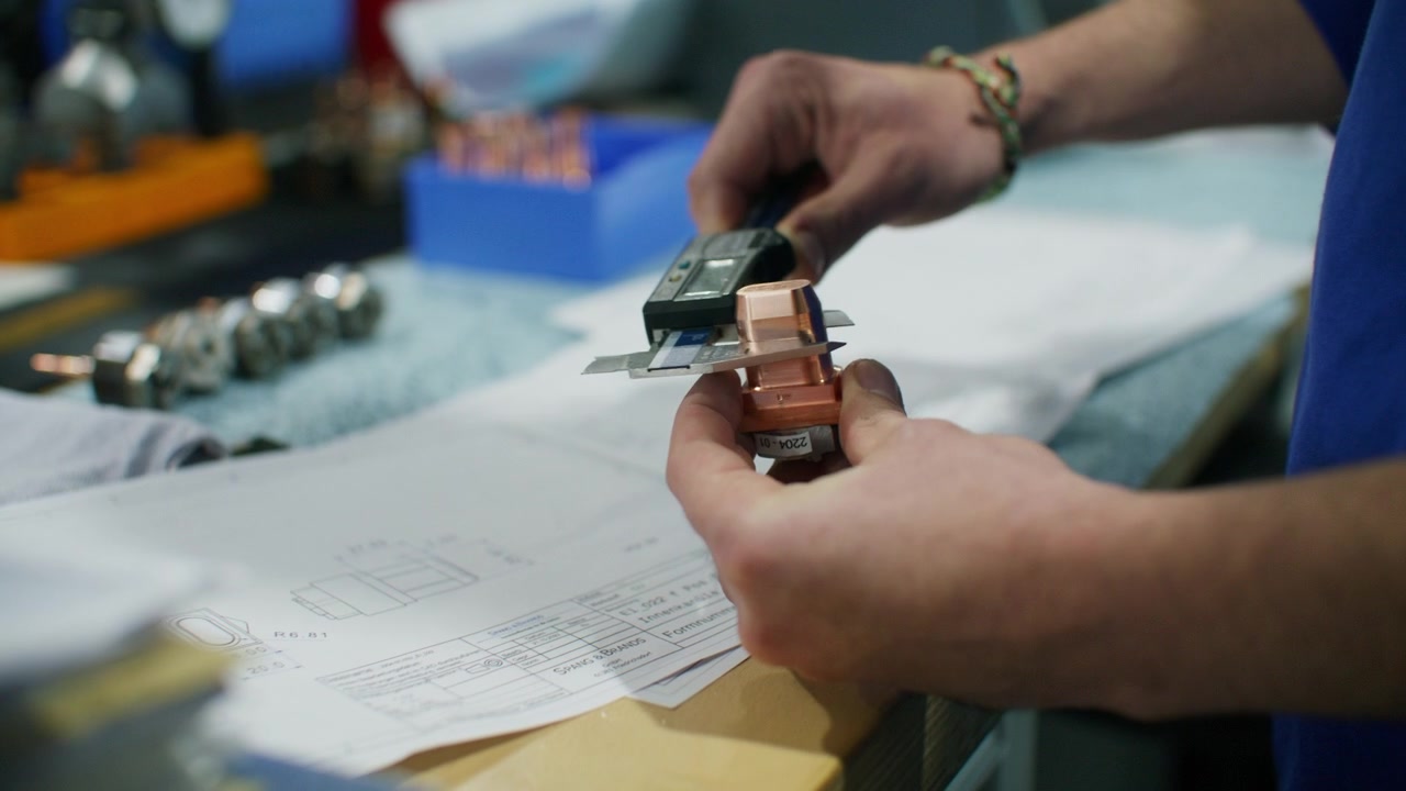 Engineer measuring detailed specifications of product with micrometer