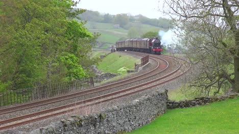 a steam train passes through the english countryside at high speed 2