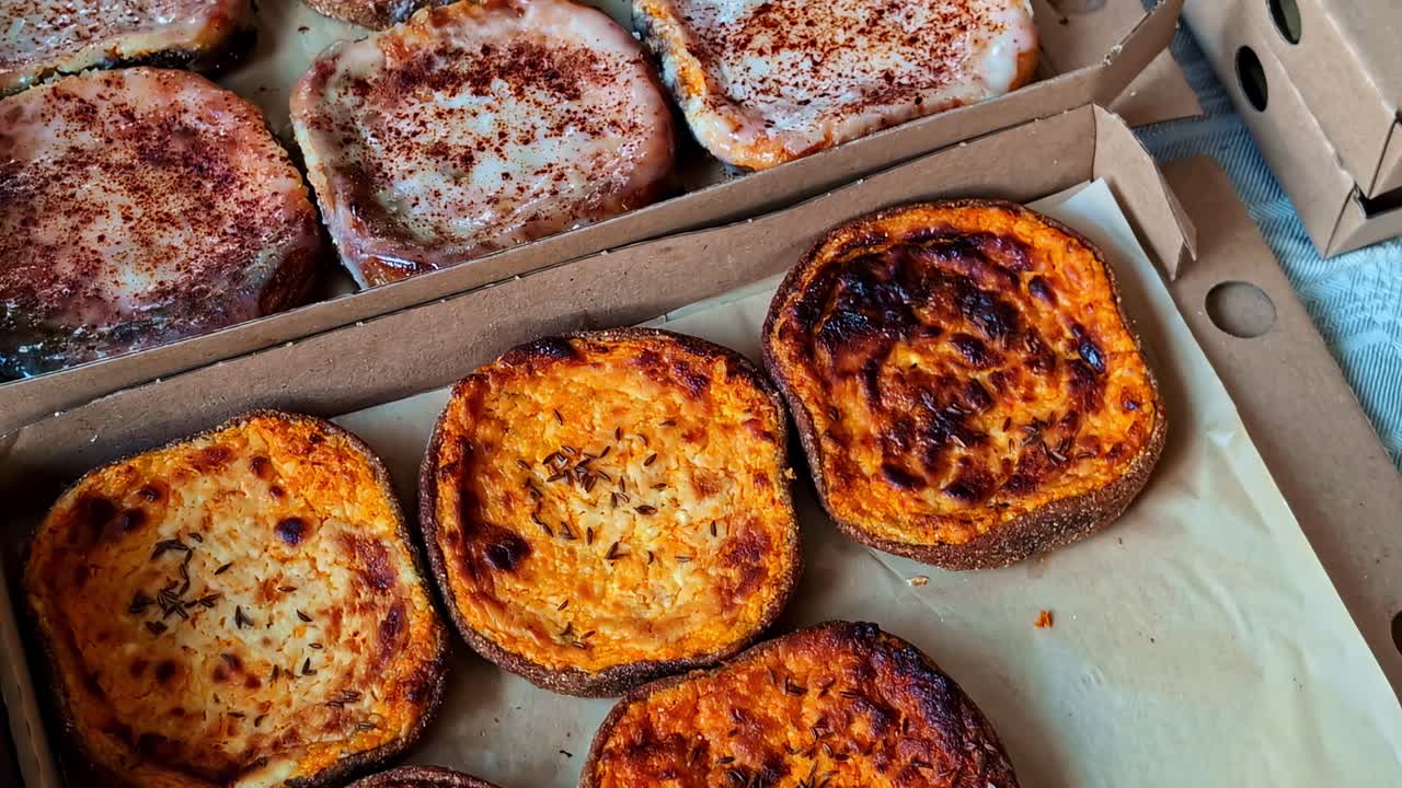 Capturing of crusty baked goods in cardboard box. Delicious