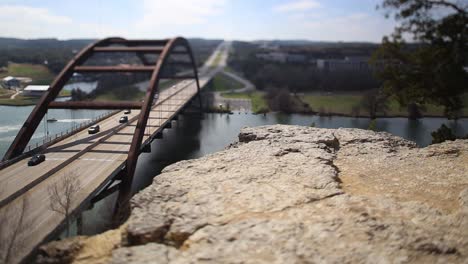 austin pennybacker bridge, focus isolates section of ledge and front part of the bridge. traffic backed up all the way across the bridge, speed slows to real time and then speeds back up.