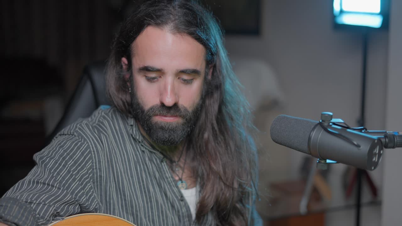 Musician Performing Acoustic Guitar in Home Studio