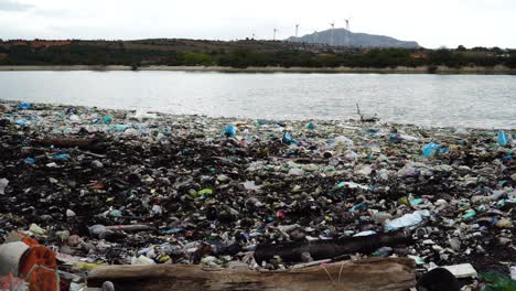 pile of waste and plastic garbage washed ashore on beach at son hai, vietnam