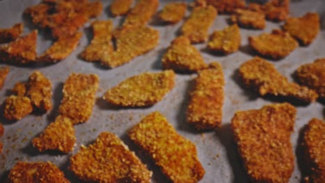 fresh delicious chicken nuggets out of the oven cooling on a sheet pan