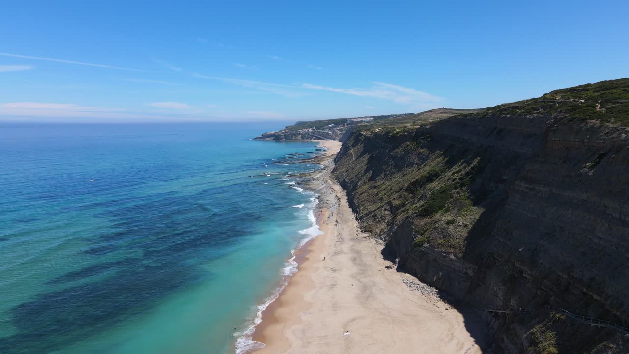 Aerial view of an amazing deserted beach surrounded by cristal clear waters and amazing cliffs