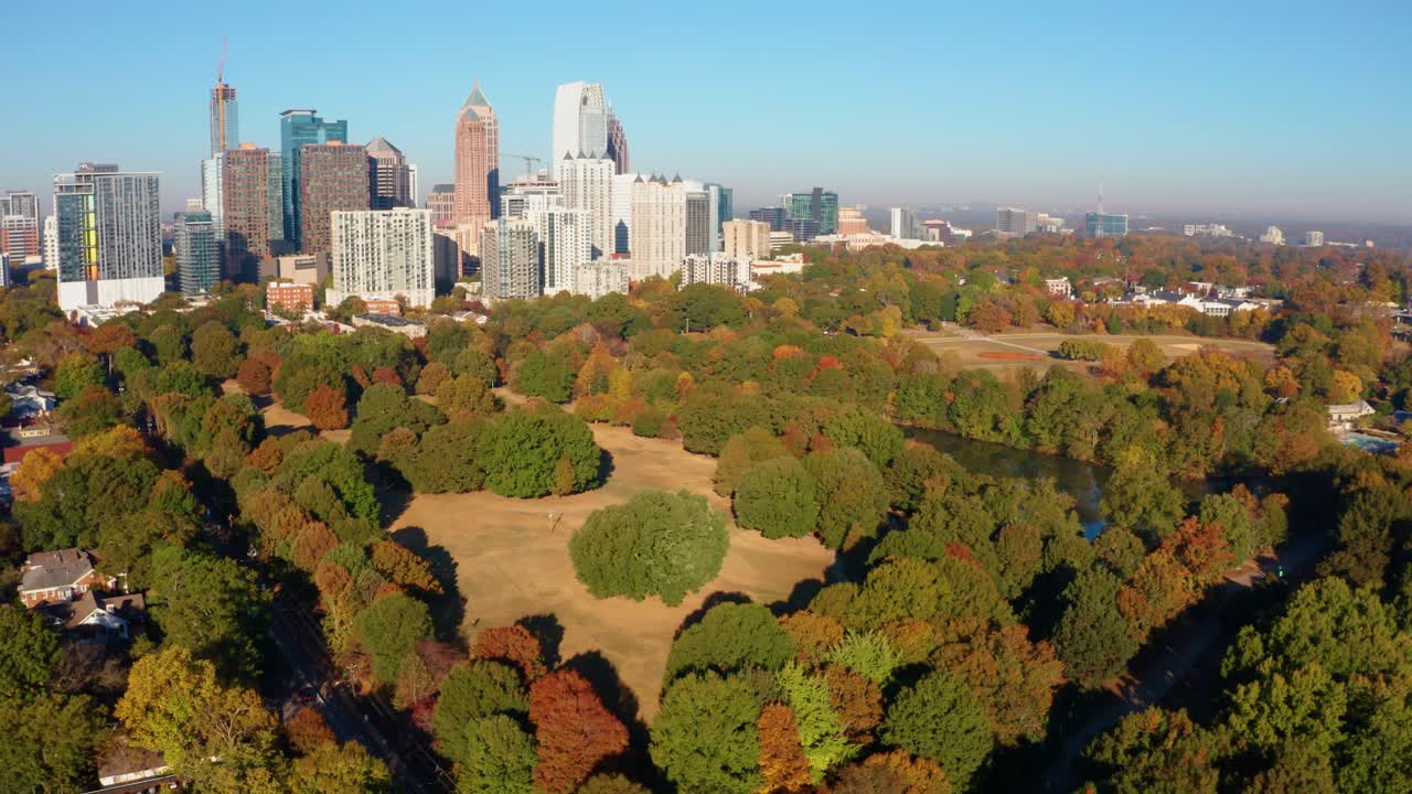 Circling downtown Atlanta Georgia above Piemont Park with lake and Fall colors