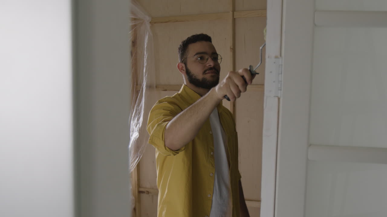 Man painting a door frame