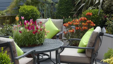 mid shot of a mature english garden with chairs and table