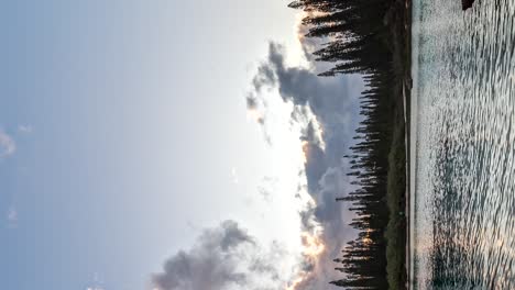 Vertical-day-to-night-colorful-timelapse-over-natural-pool-of-Oro-Bay,-Isle-of-Pines