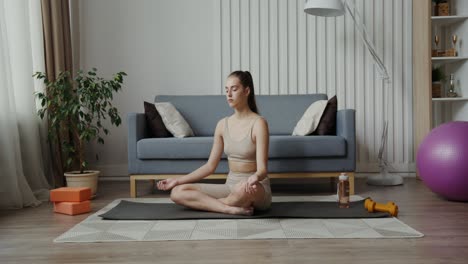 woman practicing yoga and meditation at home