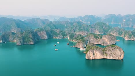 aerial drone shot over ha long bay, blue sea and limestone islands of lan ha bay