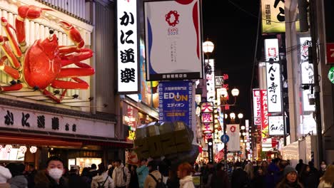 crowded street with neon signs and giant crab