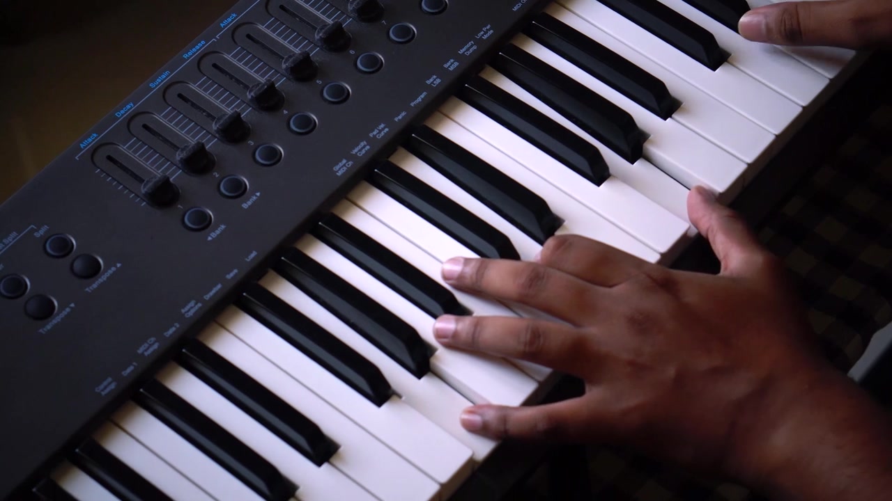 Man playing music in electric piano or electronic keyboard