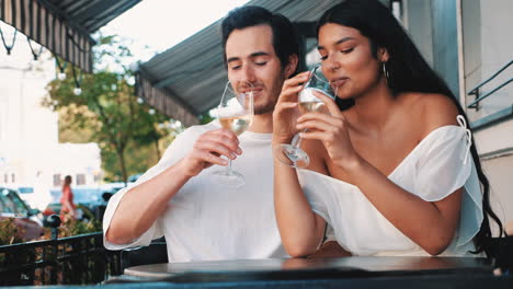 couple enjoying wine at an outdoor cafe