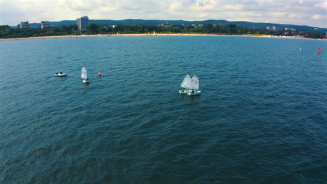 drone flying above optimist dinghy boats sailing on the baltic sea at sunny day in sopot