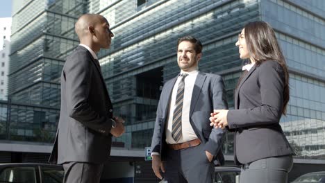 Multiethnic-business-colleagues-meeting-on-street