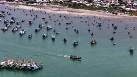 aerial view of vietnamese big trawlers and fisherman boats moored at bay , seafood business market in south east asia