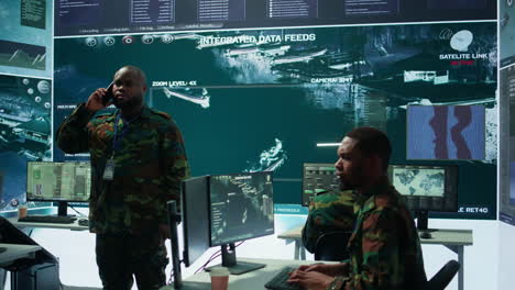 military specialist handles national operations with his crew in control center