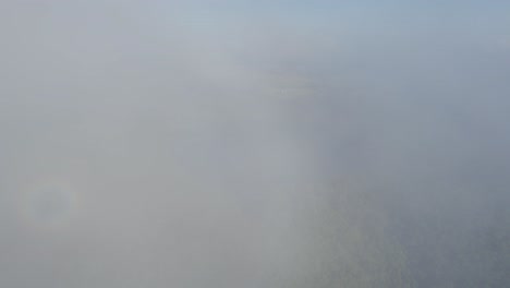 Aerial-View-Of-Lake-Eacham-On-A-Foggy-Day-In-Atherton-Tableland,-Queensland,-Australia---drone-shot