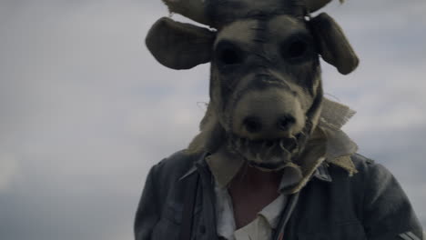 person wearing a scary cow mask
