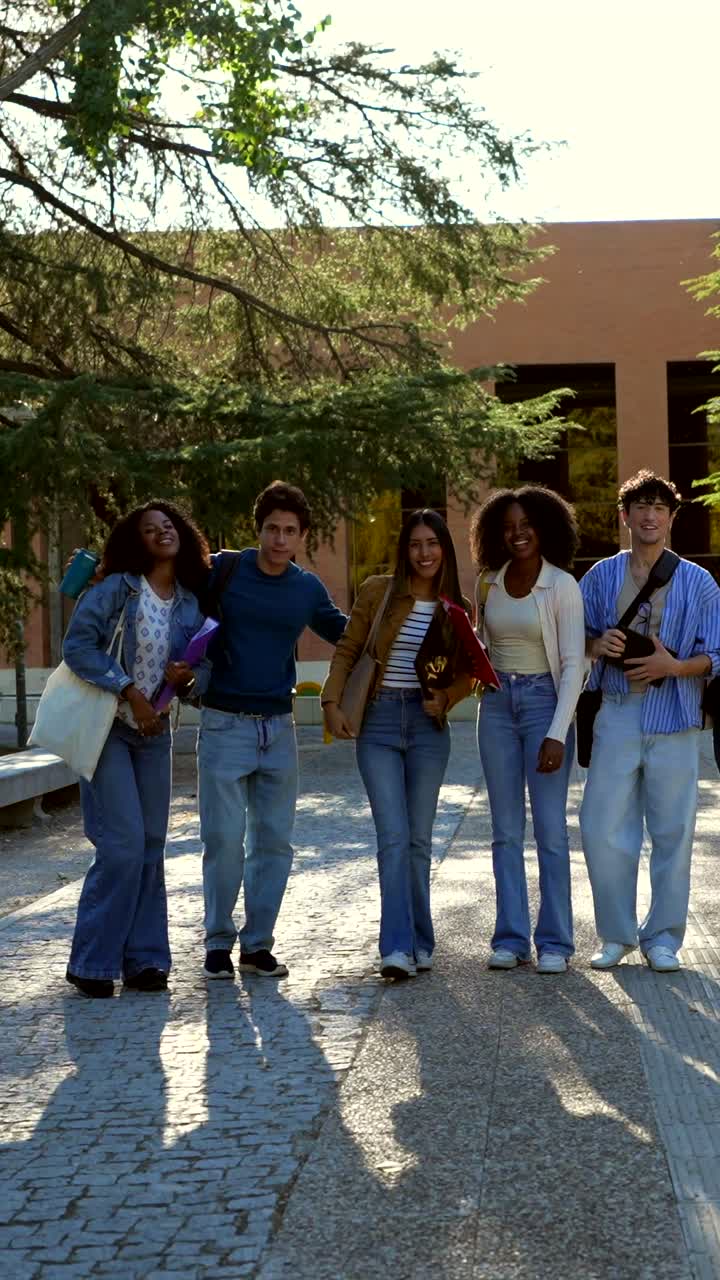 Group of students walking and laughing on campus