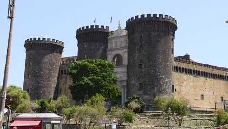 historic castle with surrounding greenery and street view