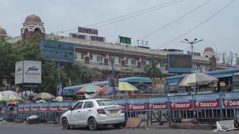 street scene outside howrah junction railway station in india
