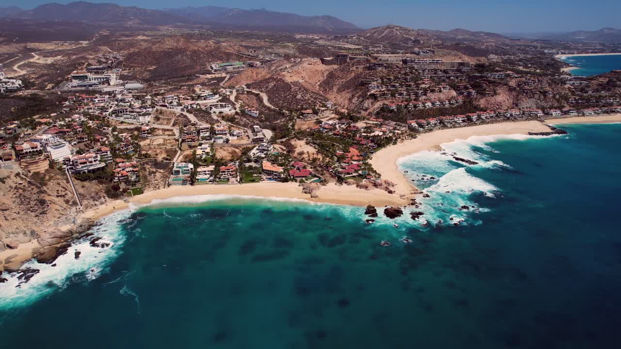 Aerial footage of ocean waves interacting with the coast of Cabo San Lucas, Mexico