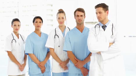 frowning medical team with hands together