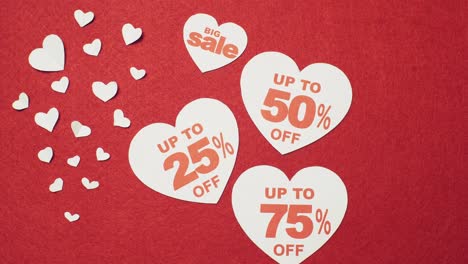 male's hand adds 50 and 75 percent written in hearts. valentine's day big sale