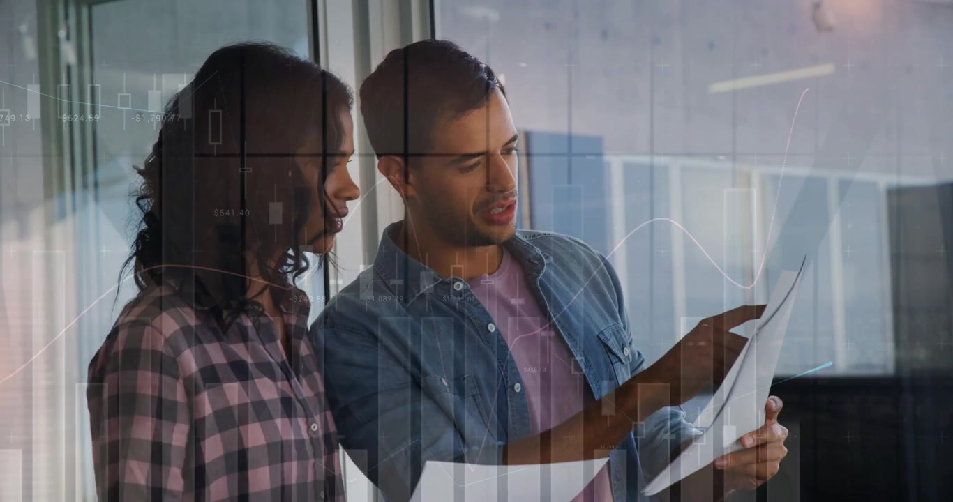 Man raising sheet and pointing, woman listening and comparing finance docs, charts overlaying glass