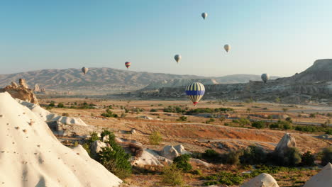 hot air balloons flying over the fairy chimneys of goreme cappadocia, turkey