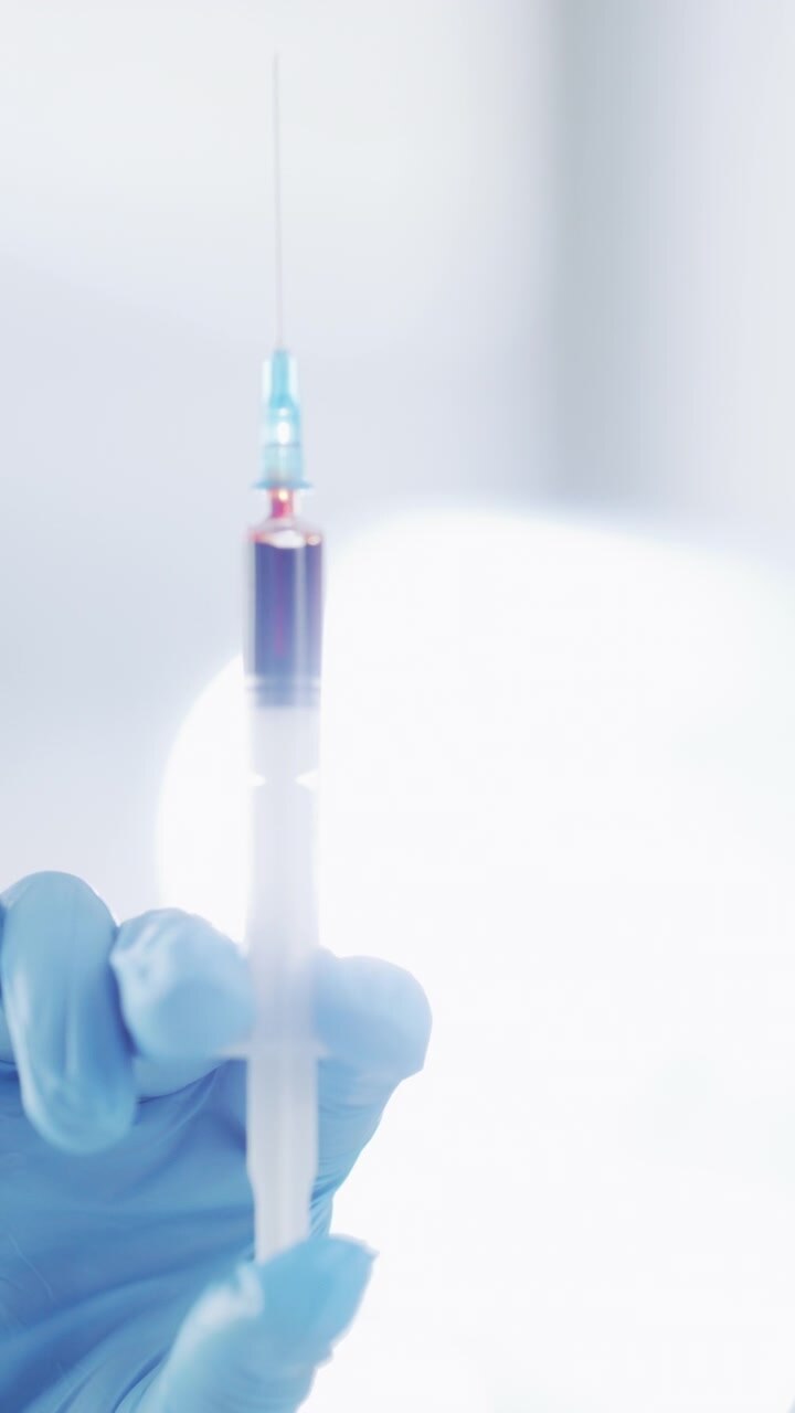 Medical Professional Holding Syringe with Blood Sample