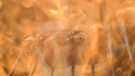 sizzling steak close-up on a grill, capturing the juice and flames in super slow motion