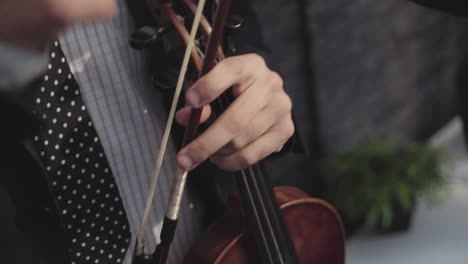 musician on his break holds his violin