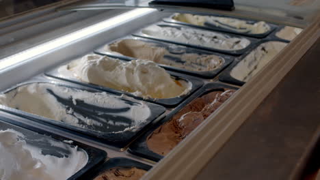 close-up-shot-of-a-worker-putting-ice-cream-into-a-cone