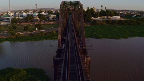 drone shot backward  the iconic black bridge in the city of culicán, sinaloa