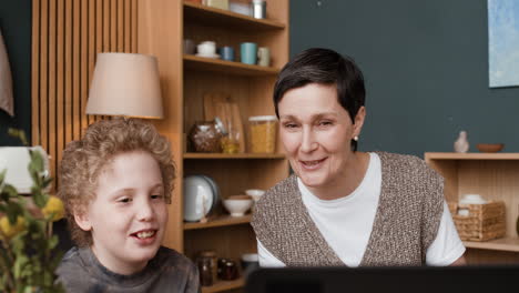 a woman and a child engaged in an activity in a kitchen setting