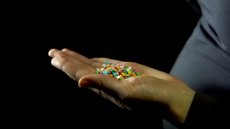 close-up confectionery powder in a human hand on a black background.