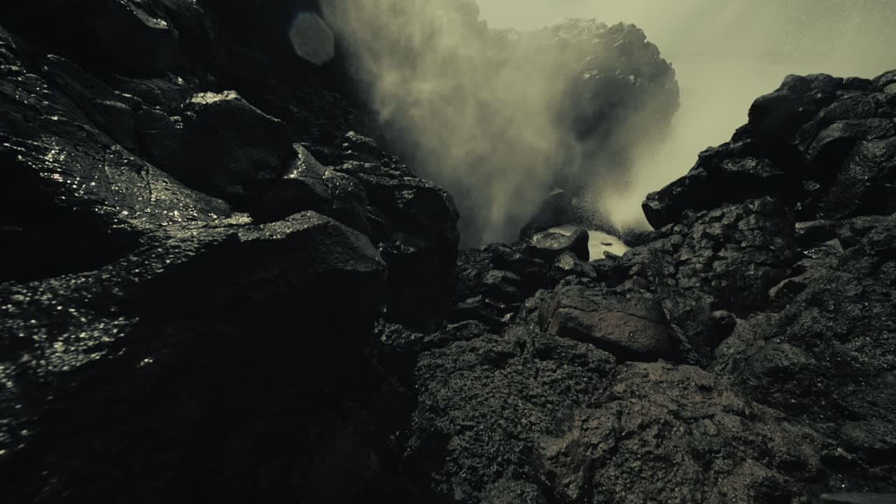 Powerful Ocean Waves Crashing Against Volcanic Rocks