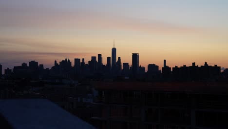 new york city skyline with world trade center viewed from brooklyn office building at beautiful sunset