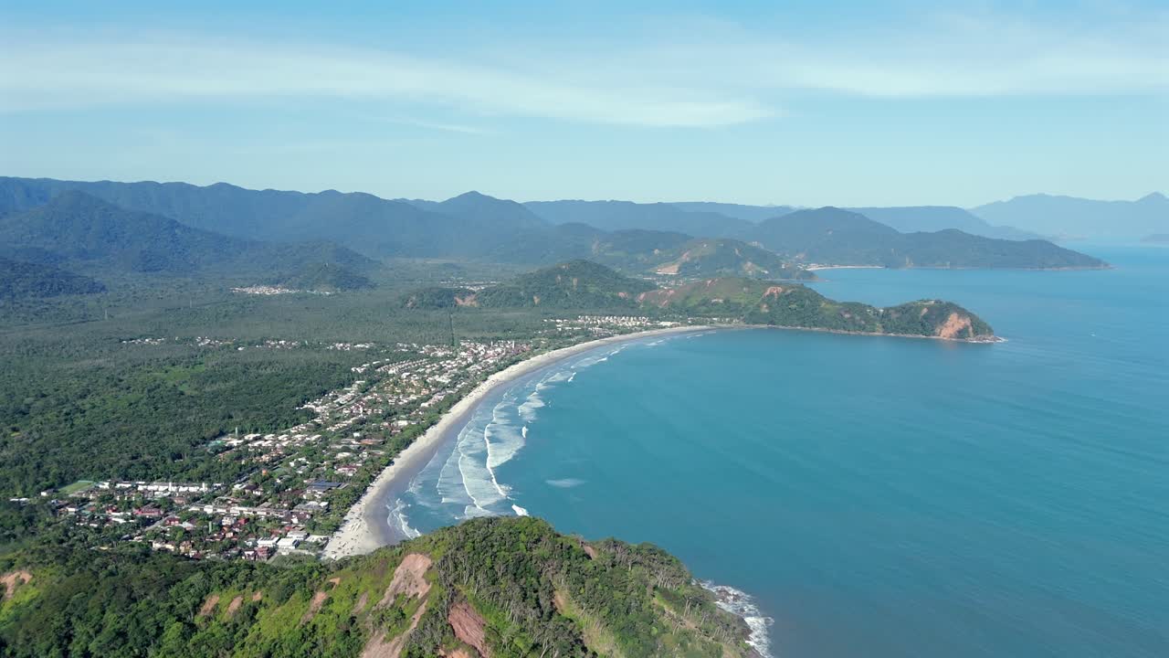 Aerial flying over sea with waves on Sao Sebastiao beach on sunny day, Brazil