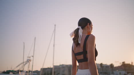 woman in fashionable attire at a marina