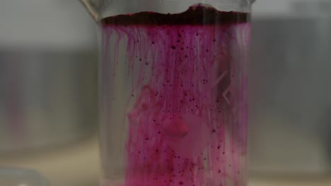 chemical experiment with pink liquid in beaker