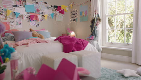 happy little girl playing with hula hoop in bedroom having fun at home on weekend