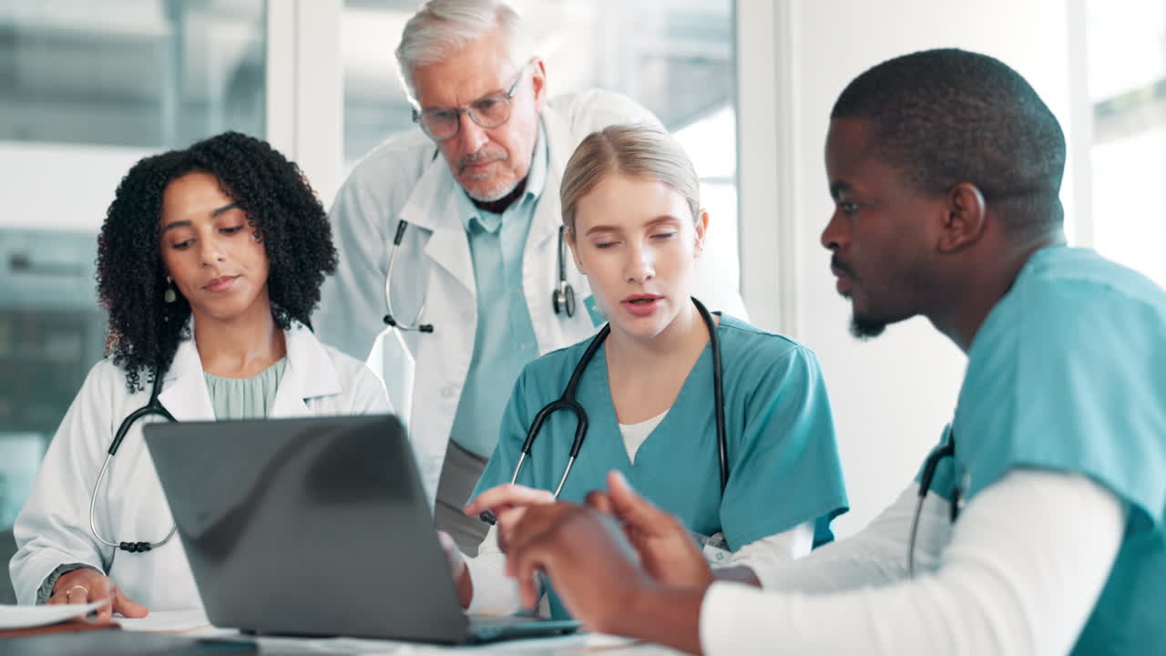 Medical Team Collaborating on Laptop
