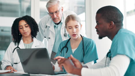 medical team collaborating on laptop