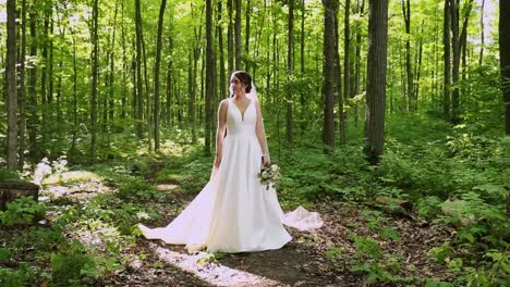 Bride-Stands-Alone-In-A-Sunny-Summer-Forest