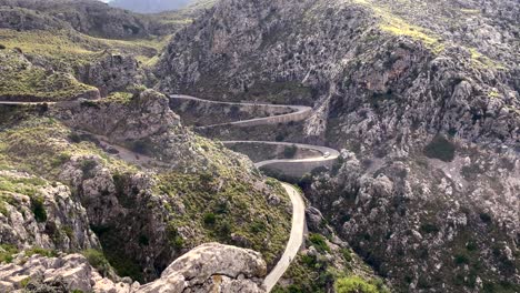 traffic at curved road in mountains, sa calobra roads mallorca, spain, aerial static view